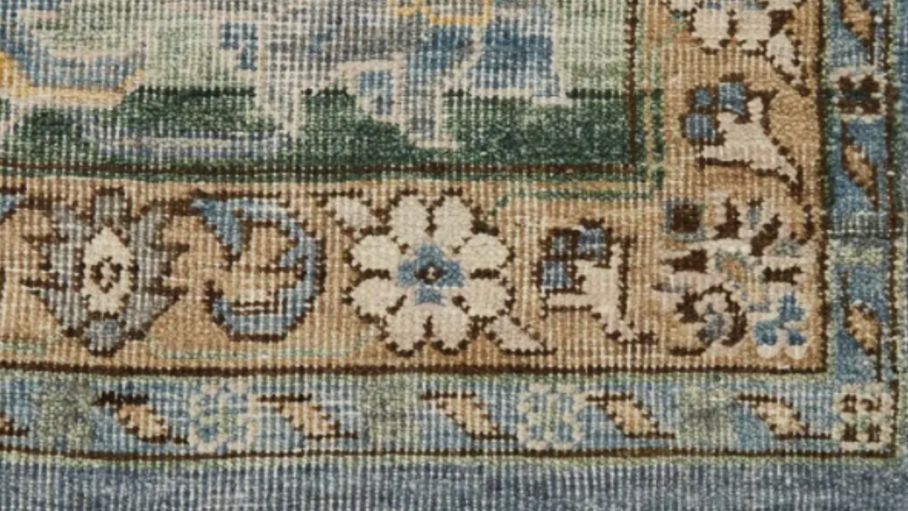 Patterned beige, green and blue rug up close