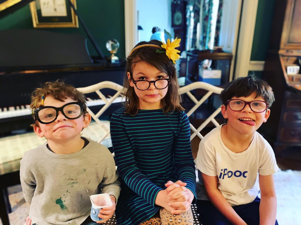 Photo of Erin's three children looking mischevious